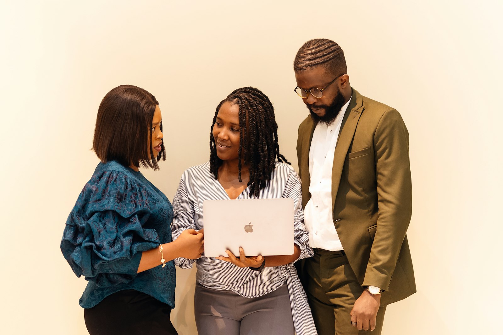 Business team gathered around a laptop reviewing a plan together