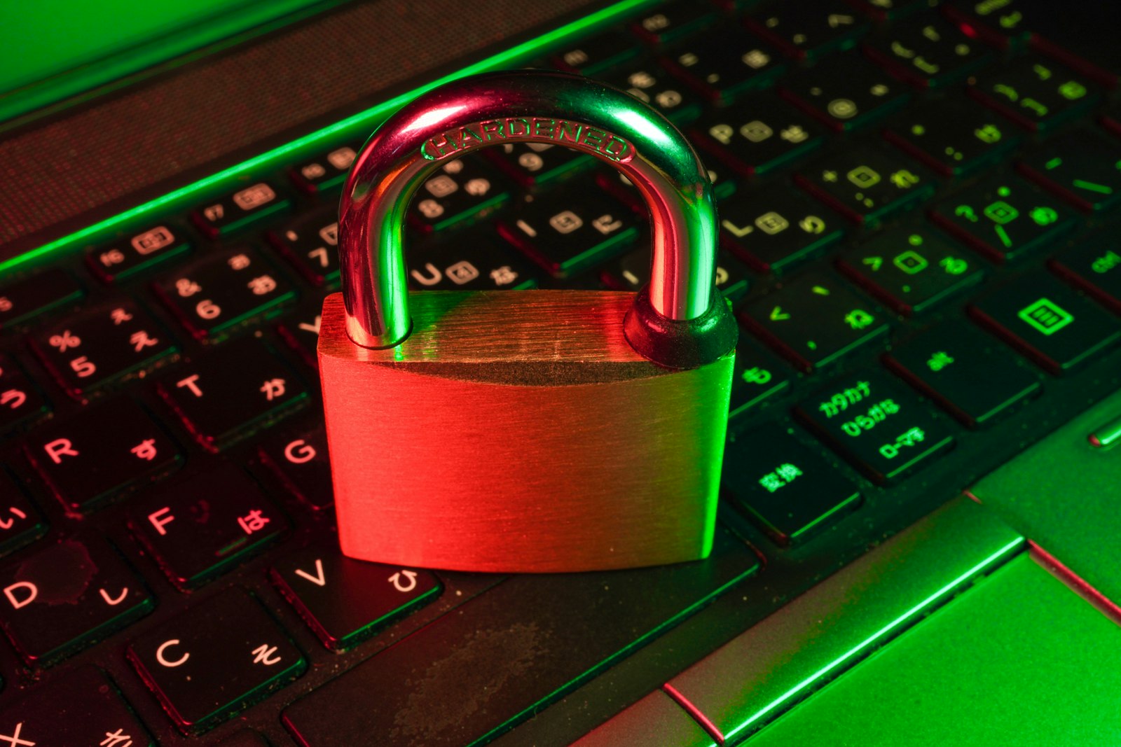 Red padlock resting on a black computer keyboard, representing data protection